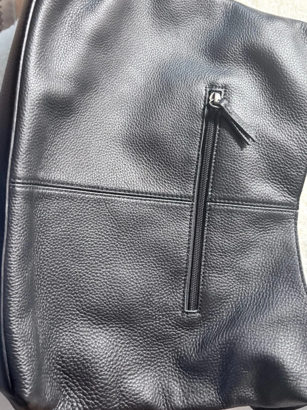 The Sak Black Leather Shoulder Bag with Tan Tassel Charm